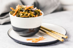 Seaweed. Carrot and onions in a bowl with chopsticks.