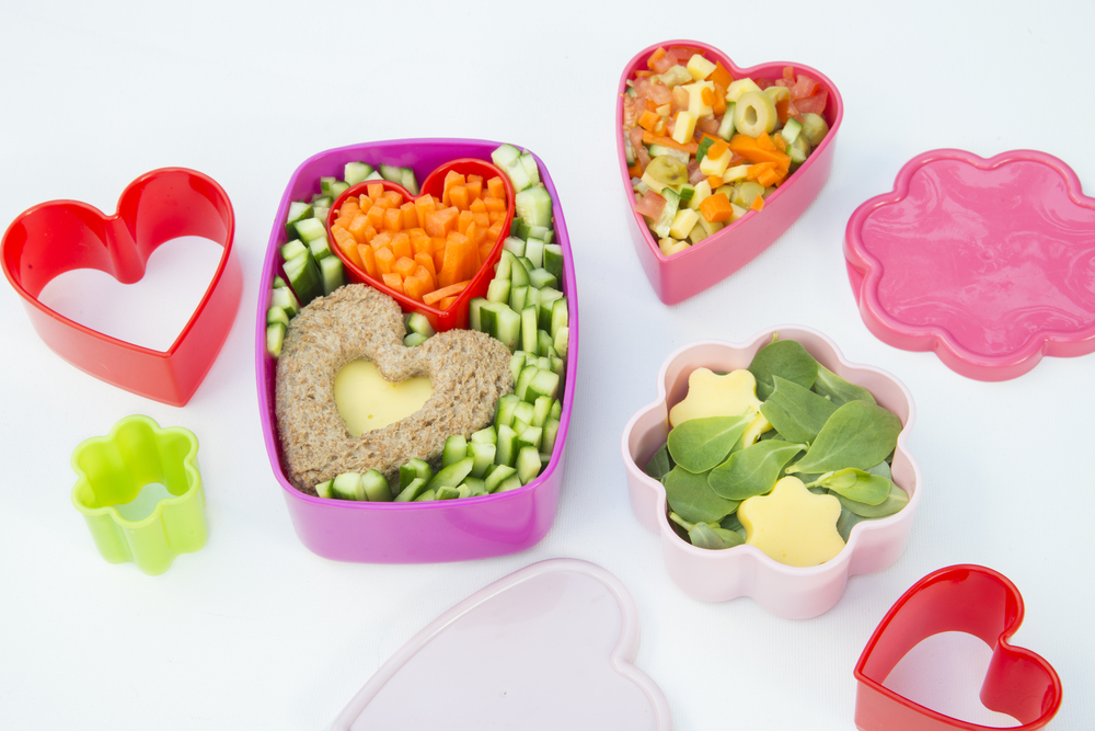 Lunch containers filled with healthy food for kids. Cookie cutters for making food in fun shapes.