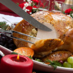 Carving roast turkey on Christmas table