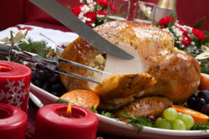 Carving roast turkey on Christmas table