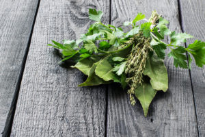 Bouquet Garni on grey wooden table.