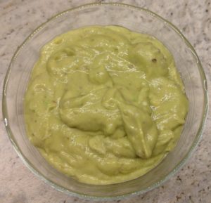 Avocado spread in glass bowl.