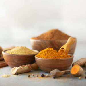 Wooden bowls of turmeric and ginger powder