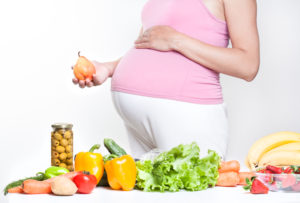 Pregnant woman with fruits and vegetables