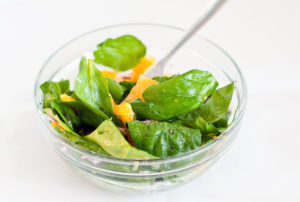 Spinach and orange salad in a bowl