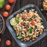 Black bean quinoa salad on rustic wooden background.